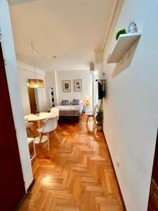 a living room with a bed and a table at Rent Ibera Nuñez in Buenos Aires