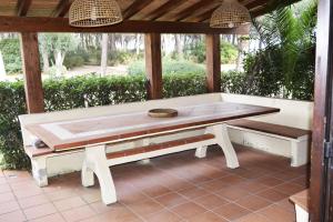 a wooden bench sitting on a patio under a gazebo at Casa Agostina in Pula