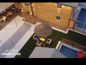 an overhead view of a patio with chairs and a pool at القصر الريفي in Al Khafji