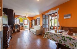 een woonkamer met oranje muren en een tafel bij Casa Iris - Versilia, Holiday Home With Pool in Gombitelli