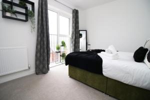 a bedroom with a bed and a large window at Church Road Cardiff FREE parking in Cardiff +59 photos