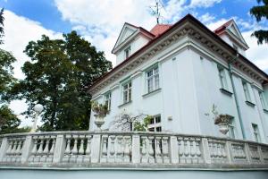 a white house with a white fence at Retro Hotel Villa Ostrava in Ostrava