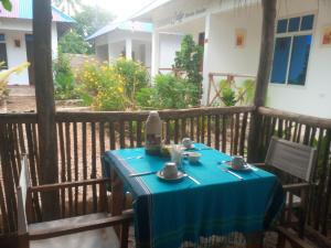 a table with a blue table cloth on a balcony at Usumba Lodge in Chejuu