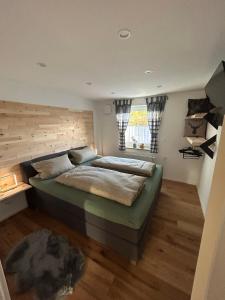 a bedroom with a large bed and a window at Ferienwohnung im Usseltal - Monheimer Alb - Altmühltal - Familie Geyer - Daiting in Monheim