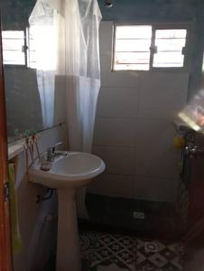 a bathroom with a sink and a shower with a window at La Floresta in La Floresta +8 photos