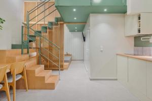 a staircase in a room with a table and chairs at Mystique Loft Ioannina in Ioannina +17 photos