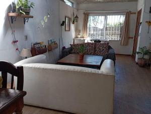 a living room with a white couch and a table at La Floresta in La Floresta