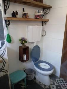 a bathroom with a blue toilet and a stool at La Floresta in La Floresta