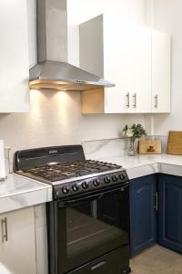 a kitchen with a black stove and white cabinets at Casa Valencia 6 in Santa Elena