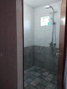 a shower with a glass door in a bathroom at Oasis Appartement in Blue Bay