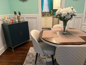 a kitchen with a table with a vase of flowers at Cozy Home in the Heart of Jackson/UMMC Hospital in Jackson