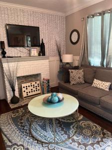 a living room with a couch and a table at Cozy Home in the Heart of Jackson/UMMC Hospital in Jackson