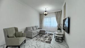 a living room with a couch and a chair at Stay in heart of Dubai Marina walk to JBR beach in Dubai