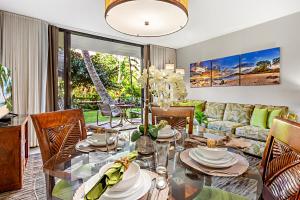 a living room with a table and a couch at Kaanapali Shores 144 in Kahana