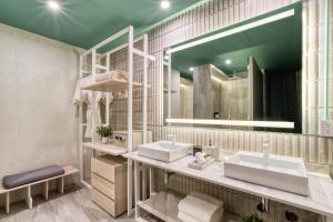 a bathroom with two sinks and a large mirror at Collections by ULIV Polanco in Mexico City +16 photos