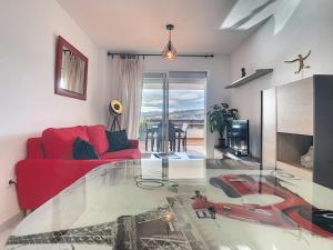 a living room with a red couch and a glass floor at Modern apartment Bodrum in Bodrum City