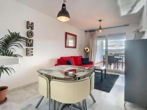a living room with a table and a red couch at Modern apartment Bodrum in Bodrum City
