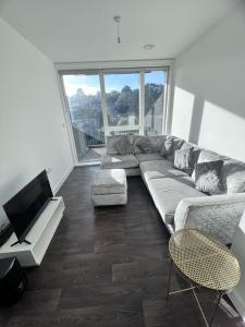 a living room with a couch and a flat screen tv at Remarkable 1-Bed Apartment in London with balcony in London