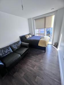 a living room with a bed and a couch at Remarkable 1-Bed Apartment in London with balcony in London