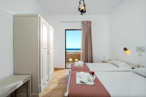 a hotel room with two beds and a window at Matzi Hotel Apartments in Gerani Chanion