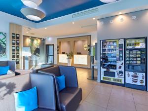 a waiting room at abucks store with blue ceilings at B&B Hotel Dortmund-City in Dortmund