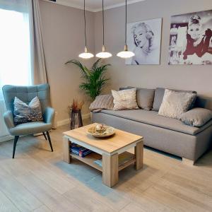 a living room with a couch and a coffee table at Apartment am Hochwald in Reinhardtsdorf