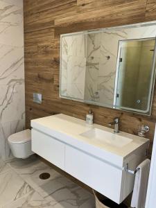 a bathroom with a white sink and a mirror at Adega D'Aldeia 