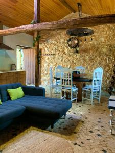 a living room with a couch and a table and chairs at Adega D'Aldeia 