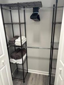 a black iron shelf with towels on it in a room at Blue house in Hampden in Baltimore