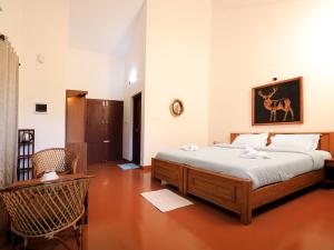 Postel nebo postele na pokoji v ubytování Dhanagiri Homestay Wayanad