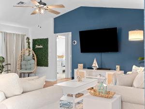 sala de estar con sofá y TV en una pared azul en Beautiful Home in Venice - 10 min from beaches! en Venice