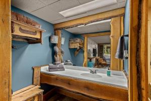 a bathroom with a sink and a mirror at Stonegate Lodge W Pool & Outdoor Firepits Room #201 in Eureka Springs