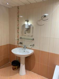 a bathroom with a white sink and a mirror at Sheraton apart-hotel in Cairo