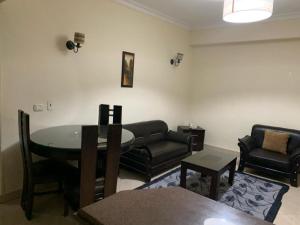 a living room with a couch and a table at Sheraton apart-hotel in Cairo