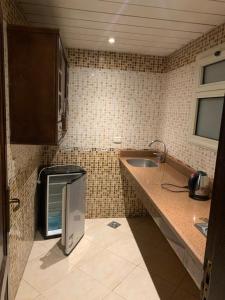 a small kitchen with a sink and a microwave at Sheraton apart-hotel in Cairo