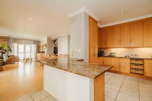a large kitchen with a large island in a room at Sidwell Gardens, Adjacent to Kingswood Estate in George +60 photos