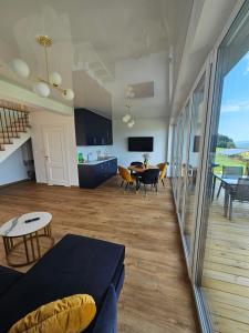 a living room with a couch and a table at Lipowe Apartmenty in Limanowa