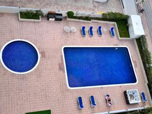 an overhead view of a swimming pool with parked cars at Stay in heart of Dubai Marina walk to JBR beach in Dubai