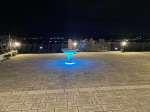 a fountain in the middle of a patio at night at B&B San Marco in San Lorenzello