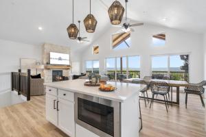 a kitchen and living room with a table and chairs at Legacy Lakeside Retreat in Kimberling City