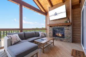 a living room with a couch and a fireplace at Legacy Lakeside Retreat in Kimberling City