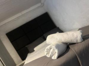 a white towel sitting on top of a bed at An elegant stay away from home in Johannesburg