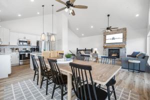a kitchen and living room with a table and chairs at Feels Like Summer in Kimberling City