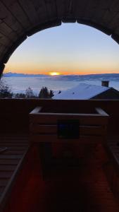 a view of the sunset from a building with a window at Ferienhaus Almzeit Koralpe in Rieding