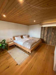 a bedroom with a bed and a wooden ceiling at Ferienhaus Almzeit Koralpe in Rieding