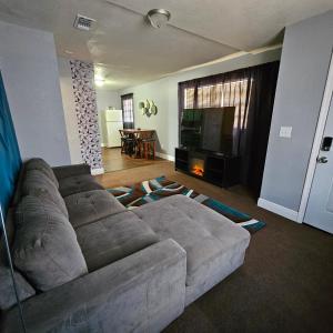 a living room with a couch and a television at Comfortable in a 2 bed 2 bath in Lakeland