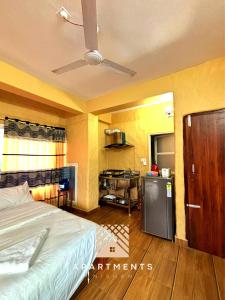 a hotel room with a bed and a kitchen at Nishan Apartments -Lakeside in Pokhara