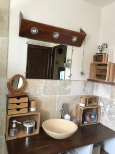 a bathroom with a sink and a mirror at Gite avec piscine Relais de la Canivotte 