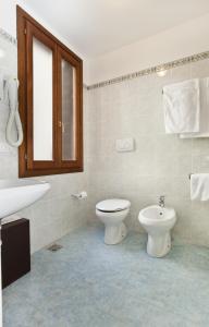 a bathroom with a toilet and a sink at Hotel San Fantin in Venice