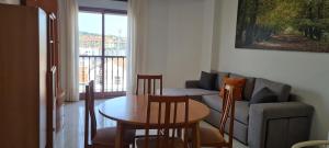 a living room with a couch and a table at Apartamentos Corea in Portonovo +12 photos